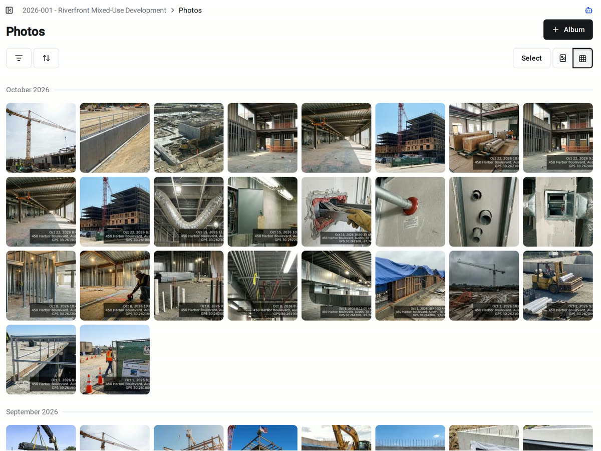 The Photos grid in Constructable, with jobsite photos from every album grouped under October 2026, several stamped with their capture date, address, and GPS coordinates