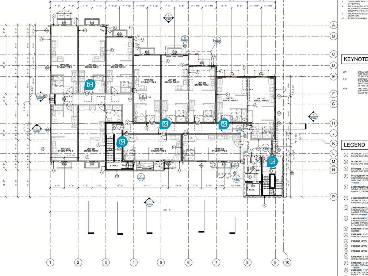 A second floor plan in the Constructable drawing viewer with five blue photo pins placed in the corridors and stair